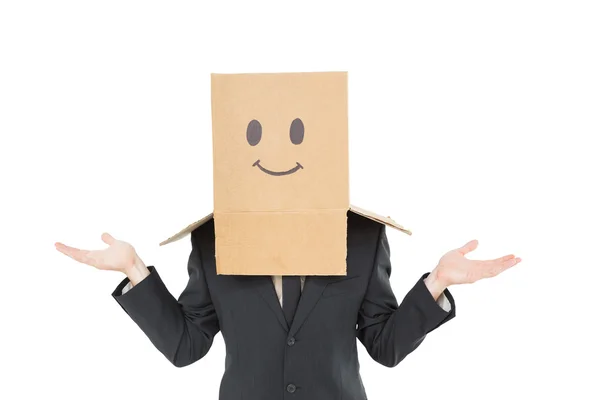Zakenman schouderophalend met doos op hoofd — Stockfoto