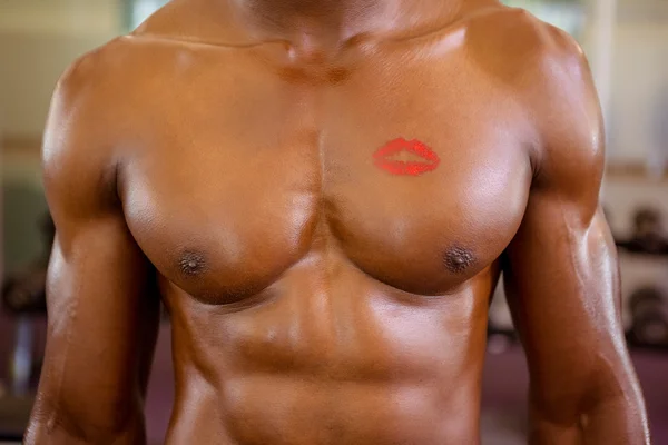 Shirtless muscular man with lipstick mark on chest — Stock Photo, Image