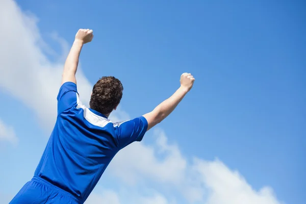 Football player in blue cheering — Stock Photo, Image