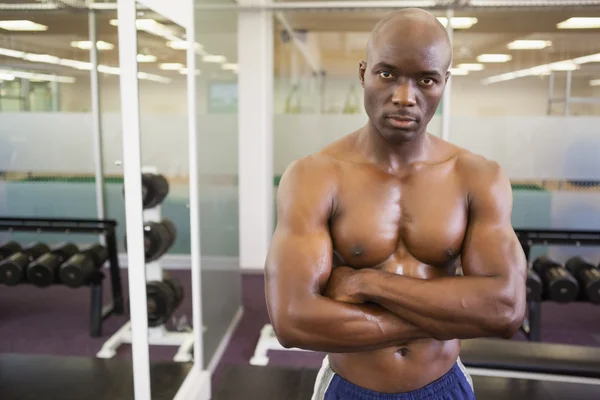 Serious shirtless muscular man in gym — Stock Photo, Image