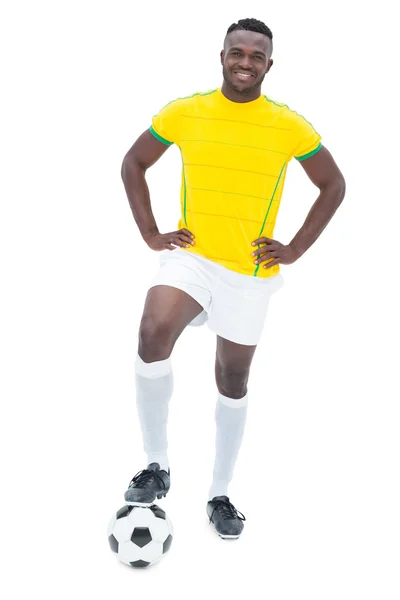Football player in yellow standing with the ball Stock Image