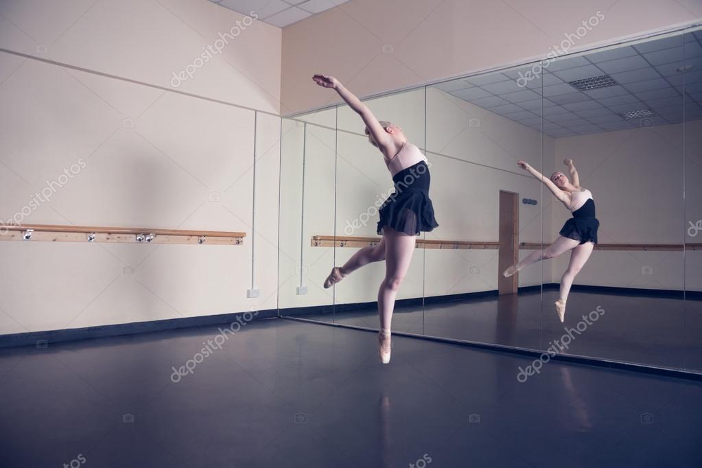 Beautiful ballerina dancing in front of mirror Photo by ©Wavebreakmedia 50053511