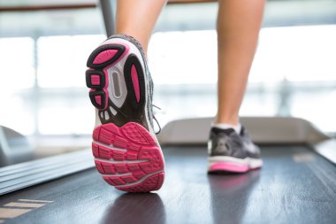 Womans feet running on the treadmill  clipart