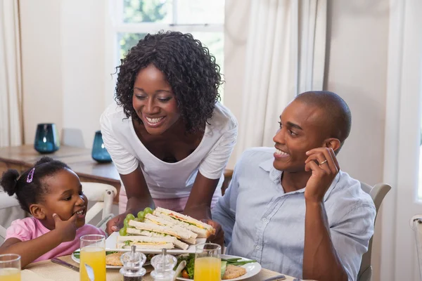 Mother serving sandwiches to her family — Stock Photo, Image