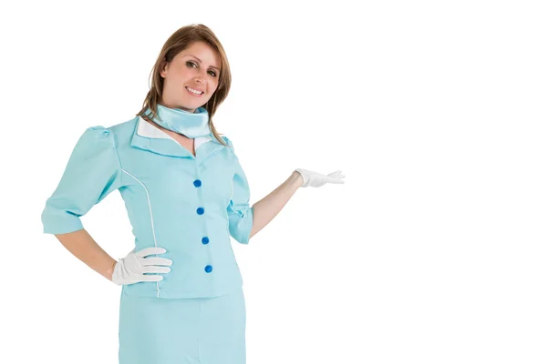 Stewardess gekleed in blauwe uniform presentatie van uw product — Stockfoto