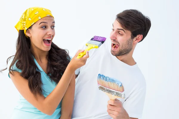 Happy young couple painting together and laughing — Stock Photo, Image