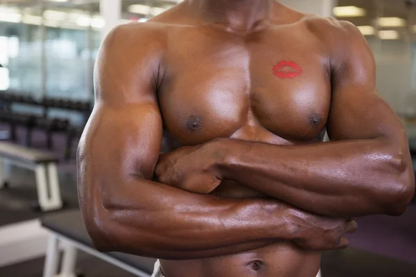 Shirtless muscular man with lipstick mark on chest — Stock Photo, Image