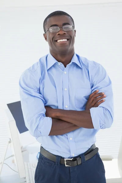 Happy businessman standing with arms crossed — Stock Photo, Image