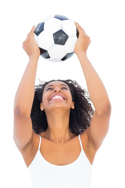 Menina bonita segurando futebol e sorrindo — Fotografia de Stock