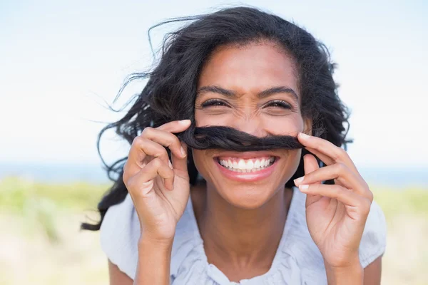 Funny woman making mustache with her hair — Stock Photo, Image