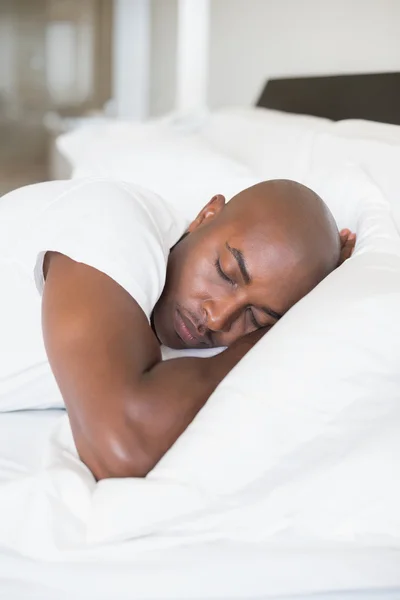 Peaceful man sleeping in bed — Stock Photo, Image