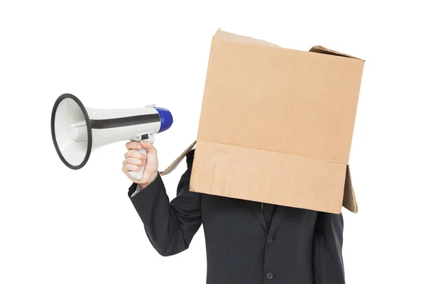 Uomo d'affari con scatola in testa contenente megafono — Foto Stock