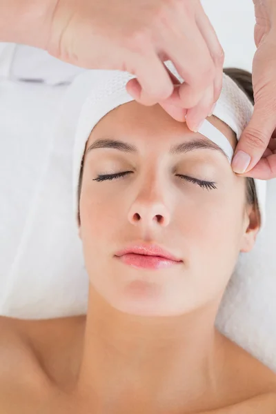 Hand waxing beautiful woman's eyebrow — Stock Photo, Image