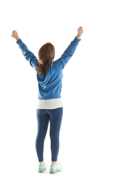 Bakifrån av ung kvinna stretching hennes händer — Stockfoto