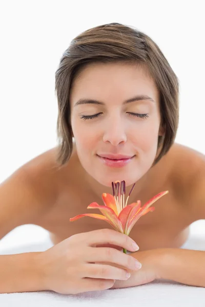 Primer plano de una hermosa joven que huele a flor — Foto de Stock