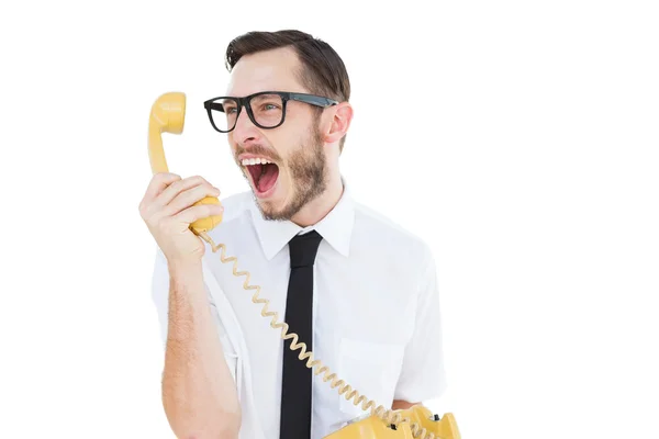 Geeky businessman shouting at telephone — Stock Photo, Image