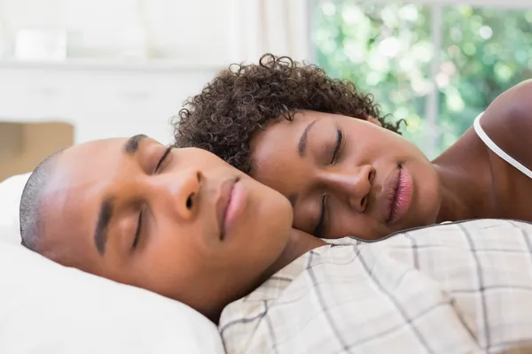 Happy couple sleeping in bed together — Stock Photo, Image