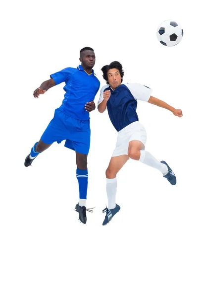 Football players tackling for the ball — Stock Photo, Image