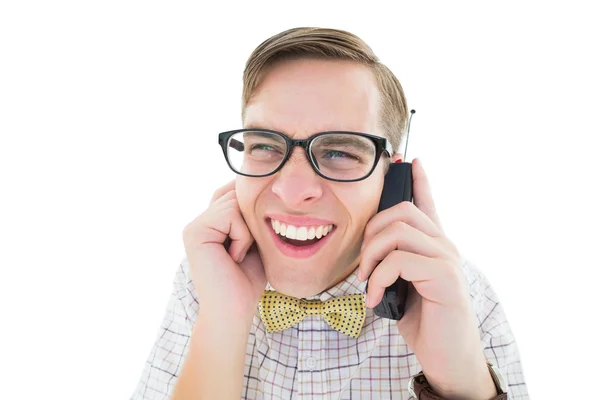 Geeky hipster holding a retro cellphone — Stock Photo, Image