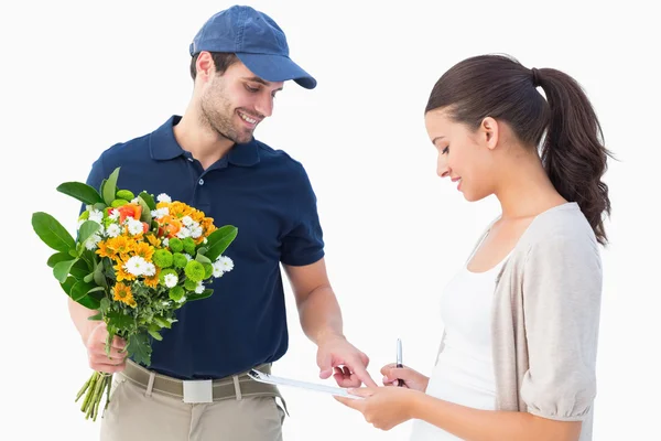 Happy flower delivery man with customer — Stock Photo, Image