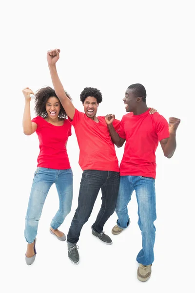 Football fans in red cheering together — Stock Photo, Image