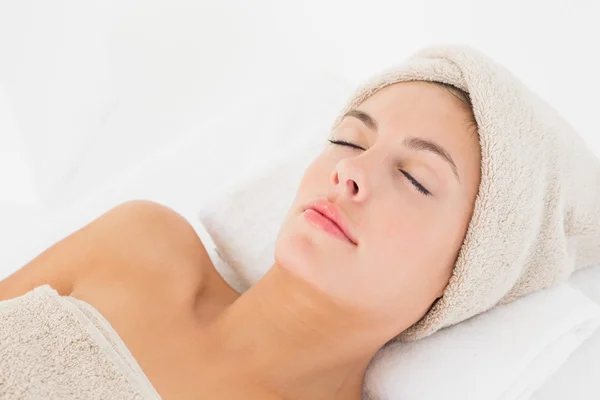 Beautiful young woman on massage table — Stock Photo, Image