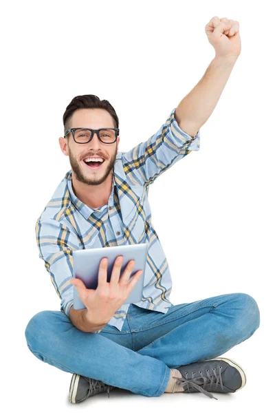 Handsome hipster using tablet pc and cheering — Stock Photo, Image