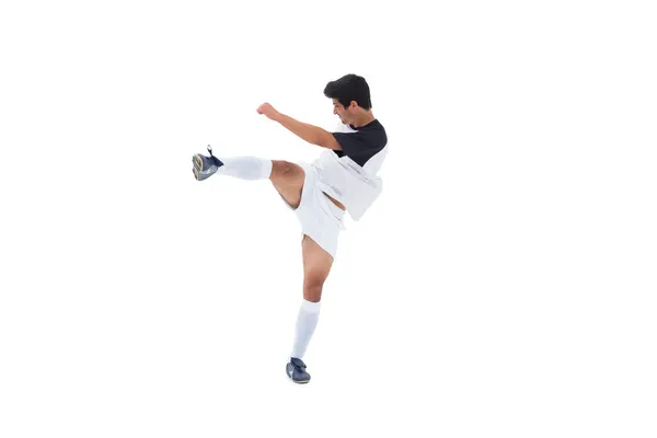 Football player in white kicking — Stock Photo, Image