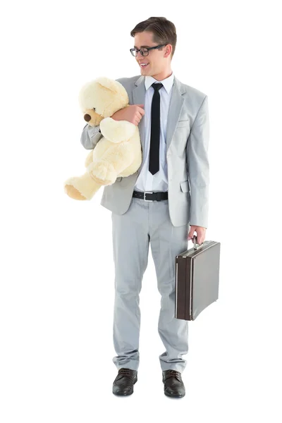 Hombre de negocios guapo sosteniendo maletín y peluche — Foto de Stock