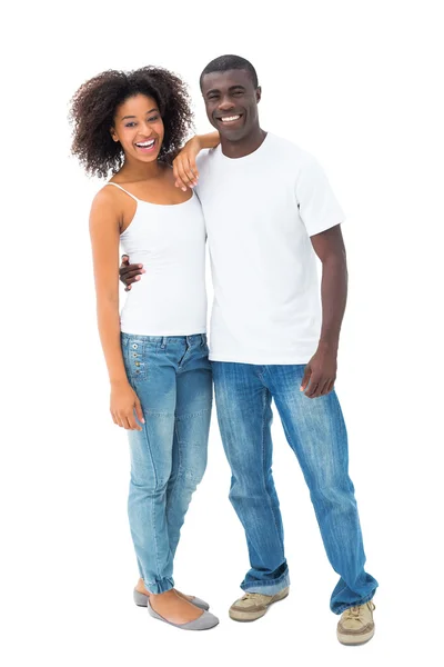 Casual paar in jeans en witte toppen glimlachen op camera — Stockfoto