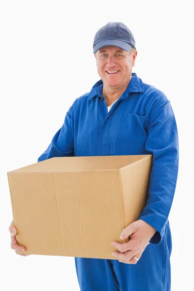 Happy delivery man holding cardboard box — Stock Photo, Image