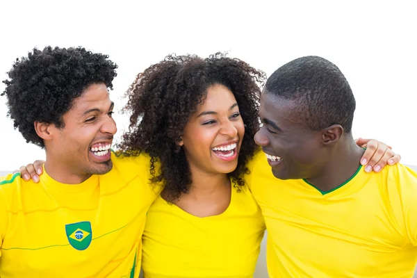 Happy brazilian football fans in yellow smiling at each other — Stock Photo, Image