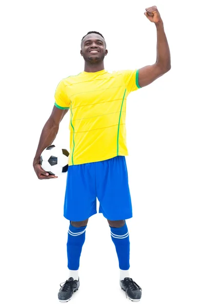 Football player in yellow celebrating a win Royalty Free Stock Photos