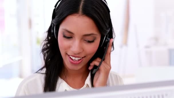 Call centre agent working and talking on headset — Stock Video