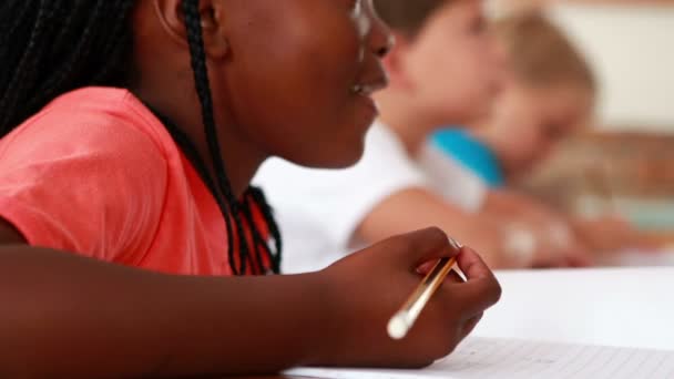 Little girl writing during class — Stock Video