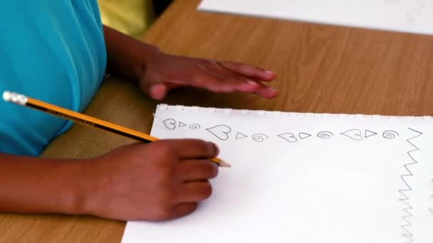 Boy doodling in white notepad — Stock Video