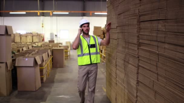 Trabajador de almacén hablando por teléfono — Vídeo de stock