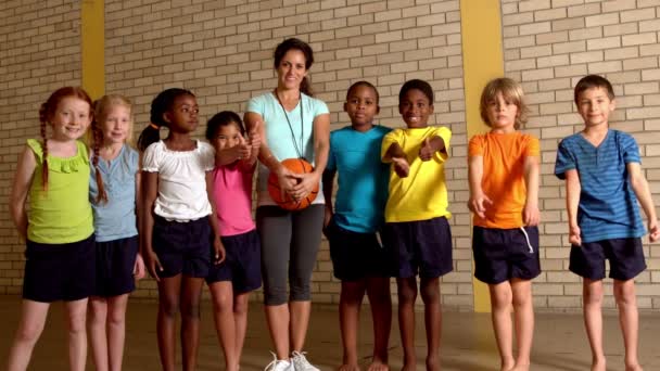 Pupils showing thumbs up with pe teacher — Stock Video