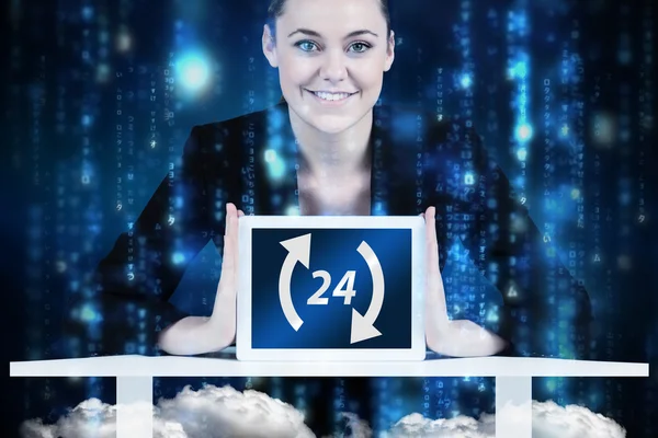 Businesswoman sitting at desk showing tablet — Stock Photo, Image