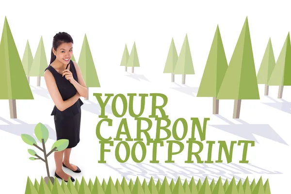 Thoughtful businesswoman against forest — Stock Photo, Image