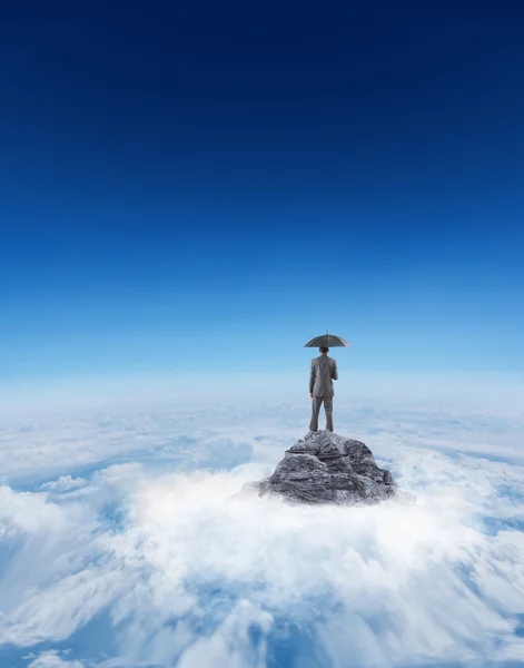 Businessman standing under umbrella — Stock Photo, Image