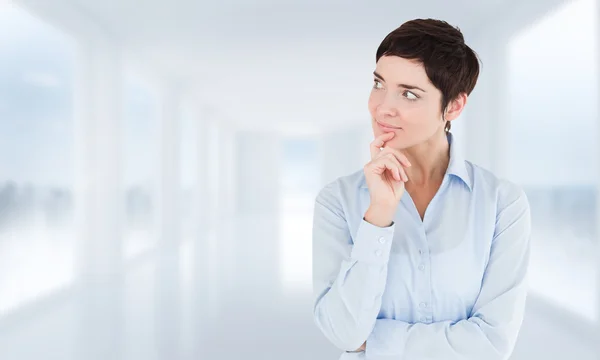 Thoughtful businesswoman with hand on her chin — Stock Photo, Image