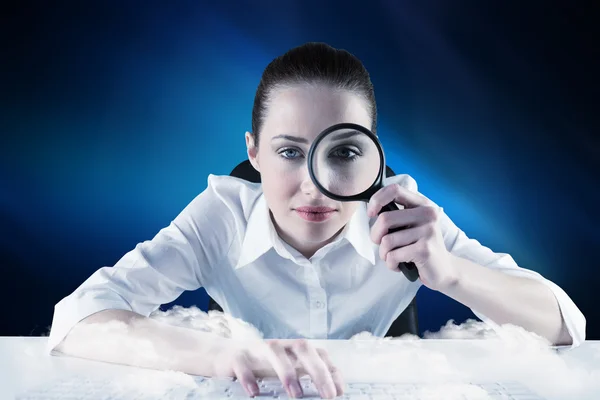 Businesswoman looking through magnifying glass — Stock Photo, Image