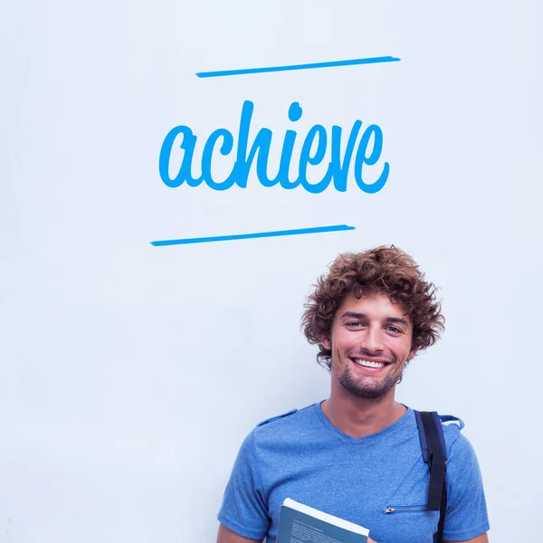 Achieve against happy student holding book — Stock Photo, Image