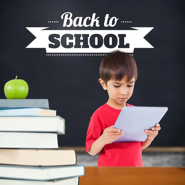 Composite image of cute boy using tablet — Stock Photo, Image