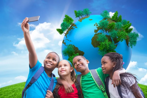 Pupils taking a selfie against green hill — Stock Photo, Image