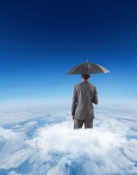 Businessman standing under umbrella — Stock Photo, Image