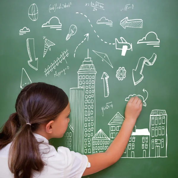 Cute pupil writing on chalkboard — Stock Photo, Image