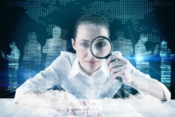 Businesswoman looking through magnifying glass — Stock Photo, Image