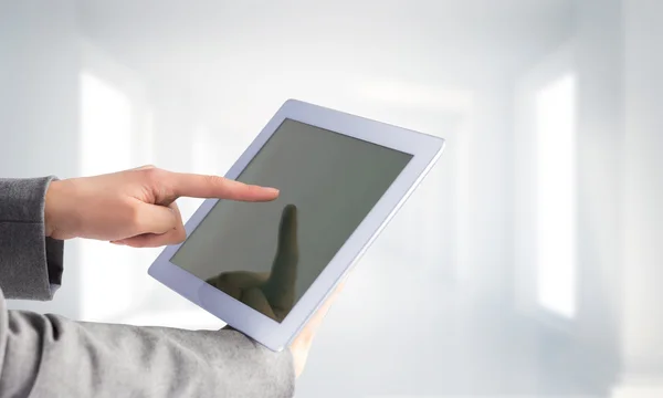 Composite image of businesswoman using a tablet pc — Stock Photo, Image